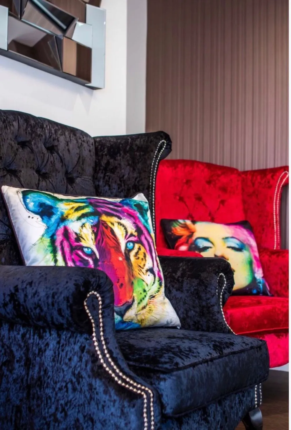 Velvet armchairs with pop-art cushions in the waiting room